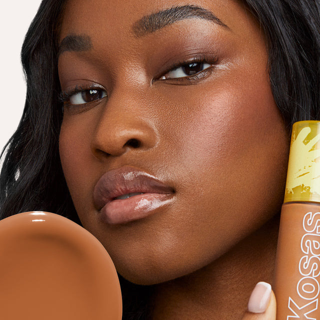 Model wearing Revealer Skin-Improving Foundation SPF 25 in Deep Warm 370