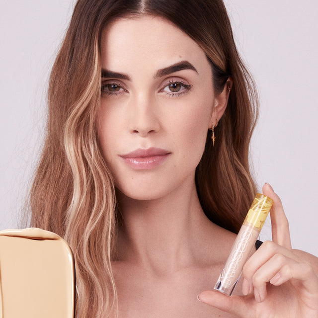Model wearing Mini Revealer Concealer in Tone 03