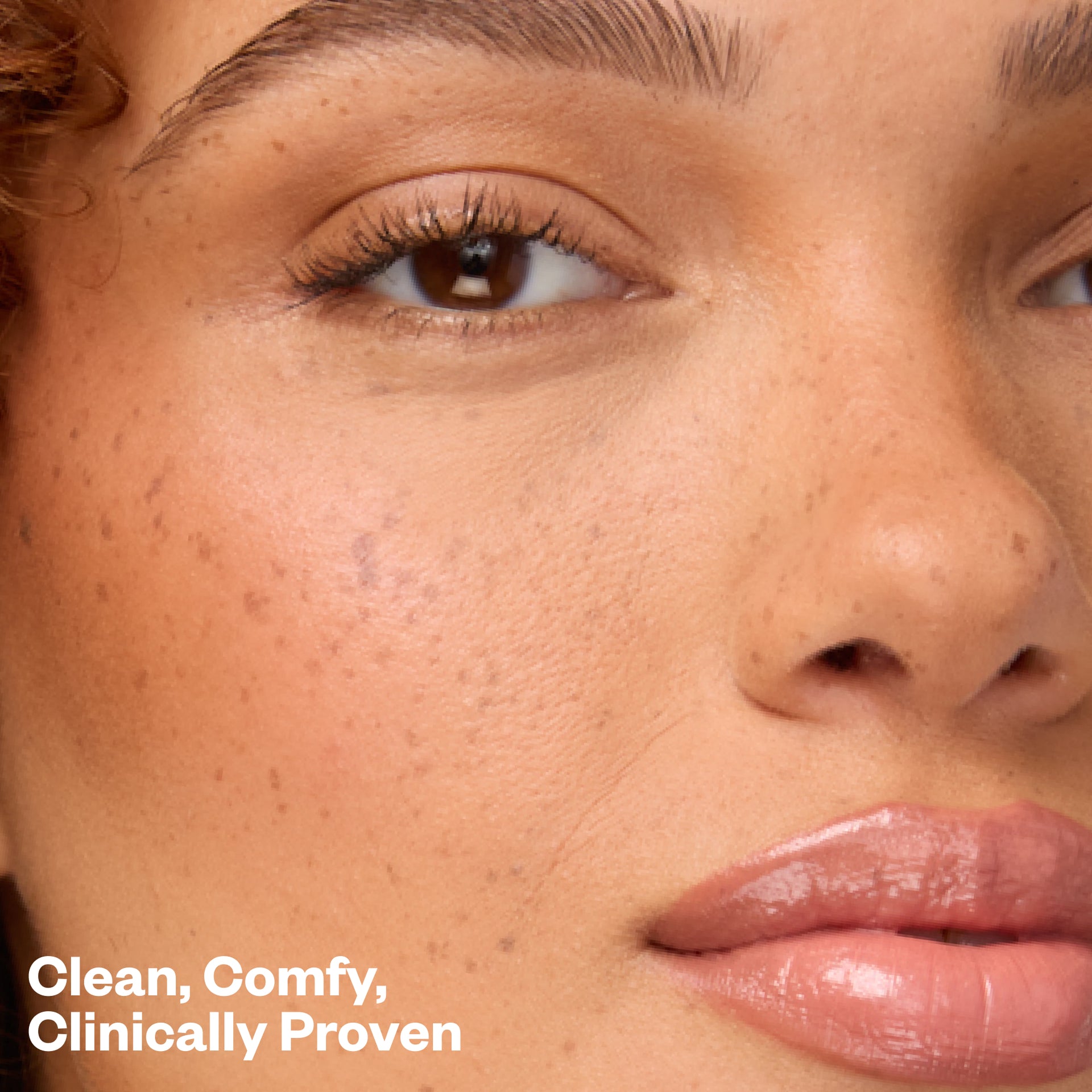 Close-up of a woman's face with text 'Clean, Comfy, Clinically Proven'