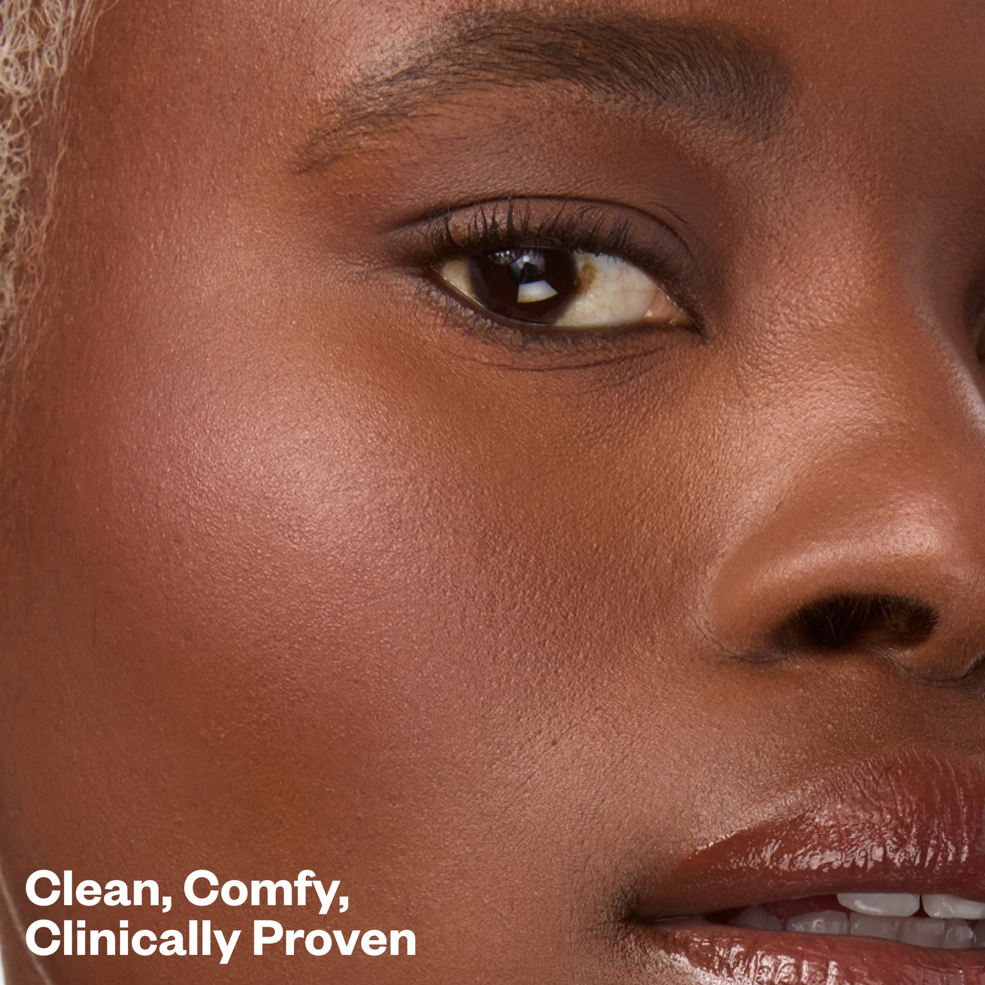 Close-up of a woman's face with text 'Clean, Comfy, Clinically Proven'
