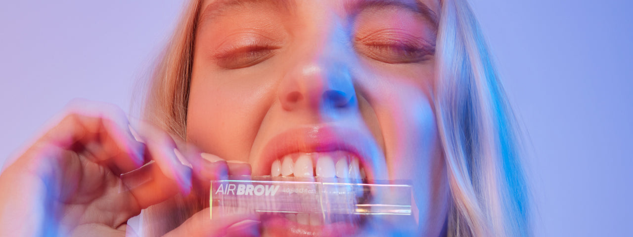 Woman biting Air Brow Clear