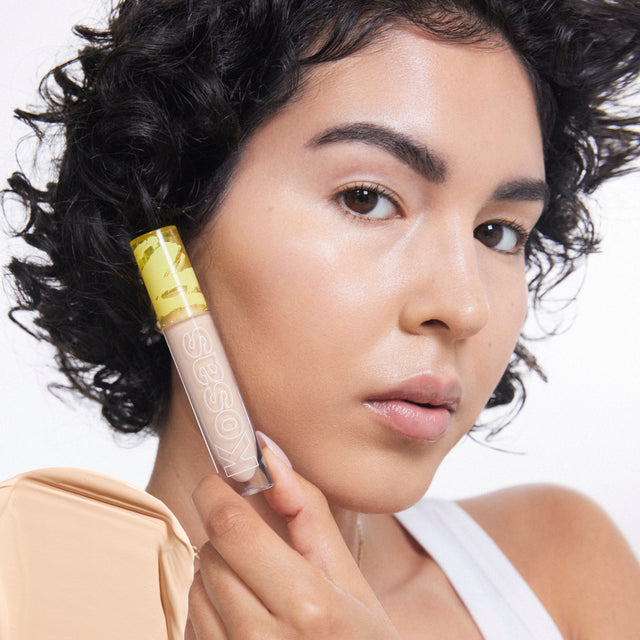 Model wearing Mini Revealer Concealer in Tone 03 W