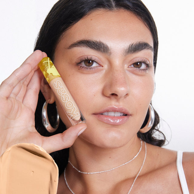 Model wearing Mini Revealer Concealer in Tone 5.8 N