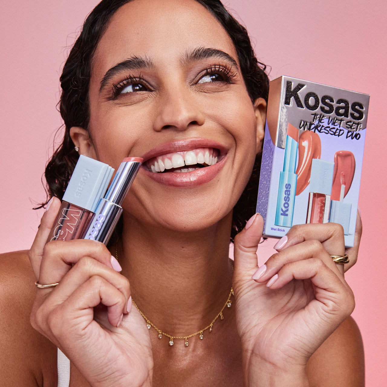 An image of a model holding the Kosas The Wet Set Undressed Duo