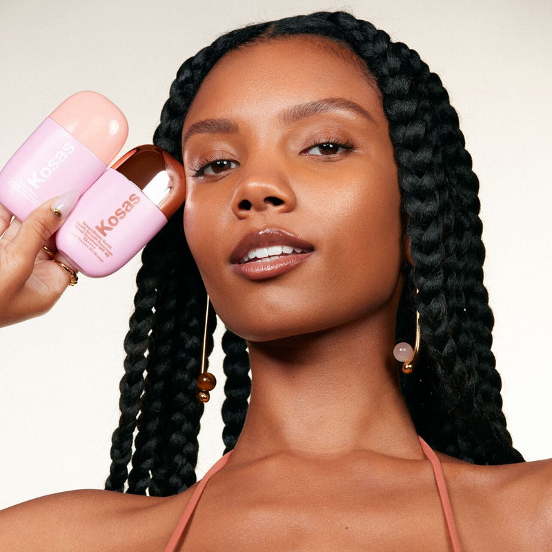 Model holding Kosas DreamBeam Original and Sunlit