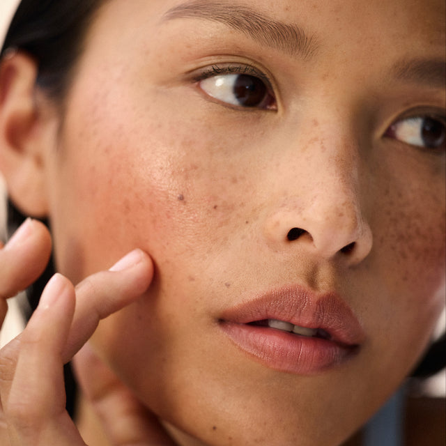 Medium skin tone model wearing Impressionist Multistick in Nuance