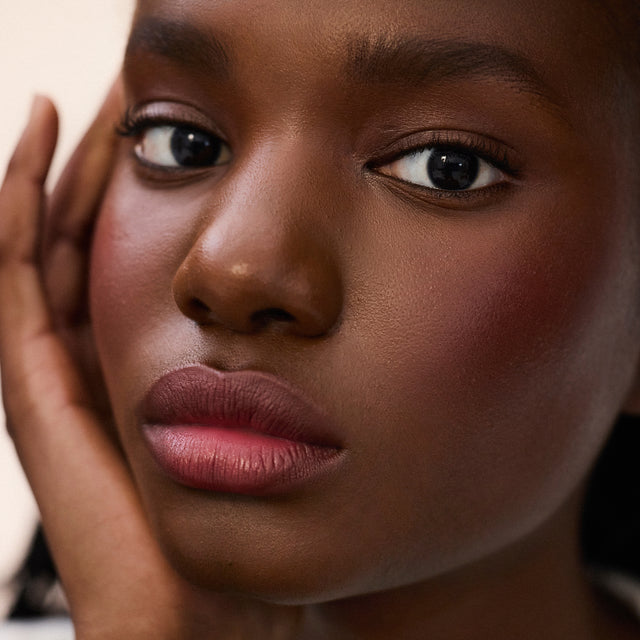 Deep skin tone model wearing Impressionist Multistick in Ripe
