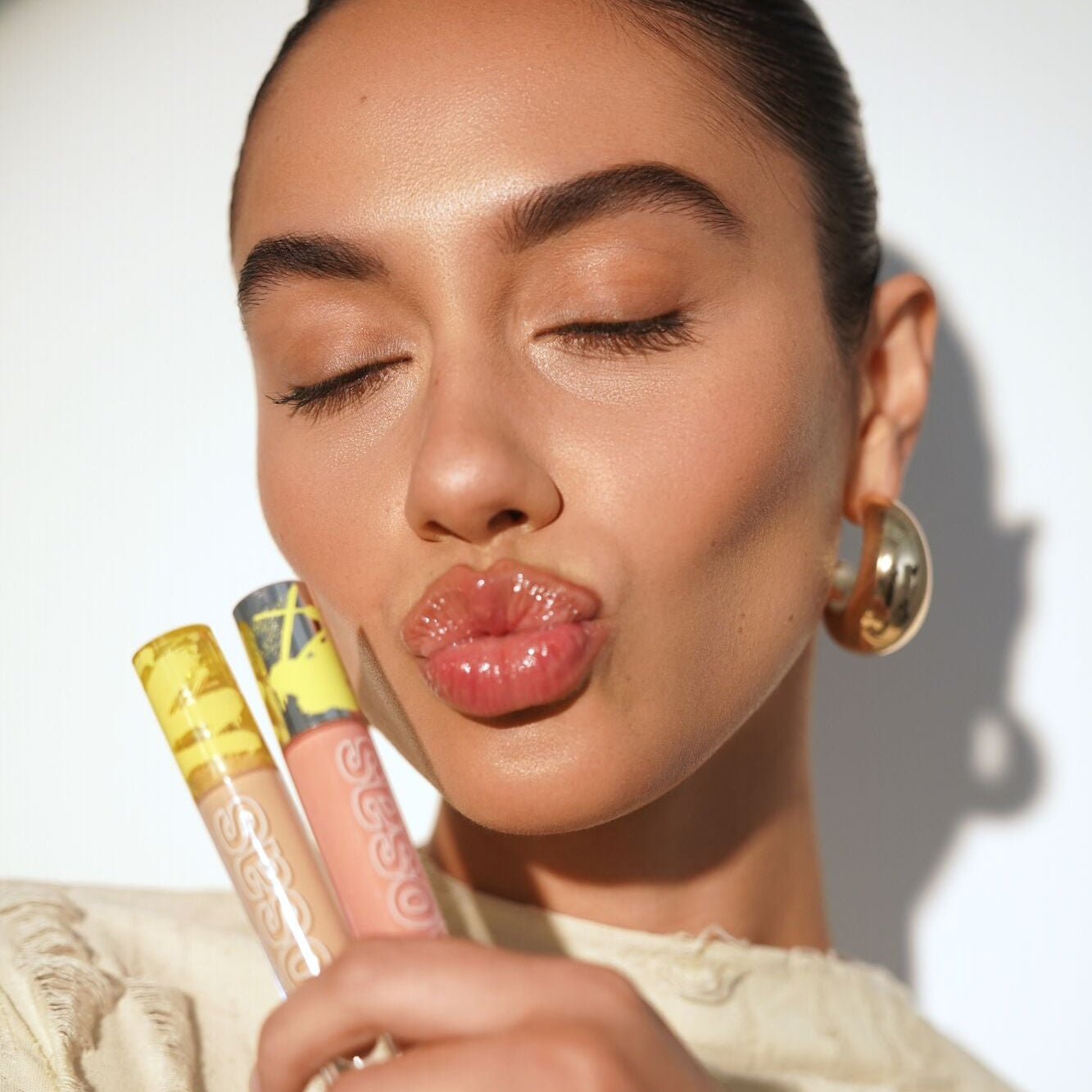 Model Holding Revealer Concealer and Extra Bright