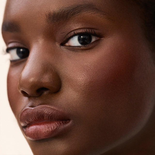 Deep skin tone model wearing Impressionist Multistick in Surreal