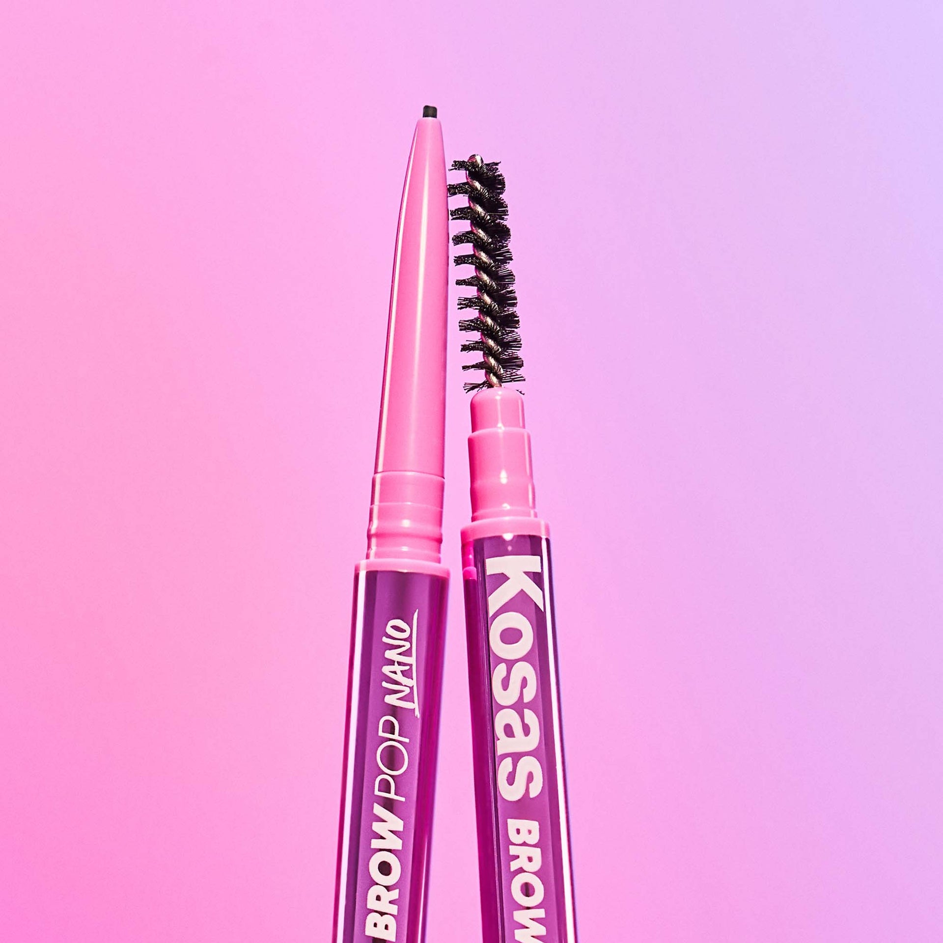 A close-up image featuring both ends of Kosas Brow Pop Nano, displaying the spoolie end and the precise tip for application.