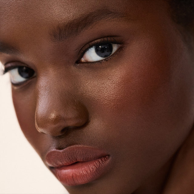 Deep skin tone model wearing Impressionist Multistick in Vital