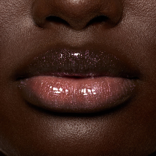 Deep skin tone model wearing Lip Pulse in Aura Flare