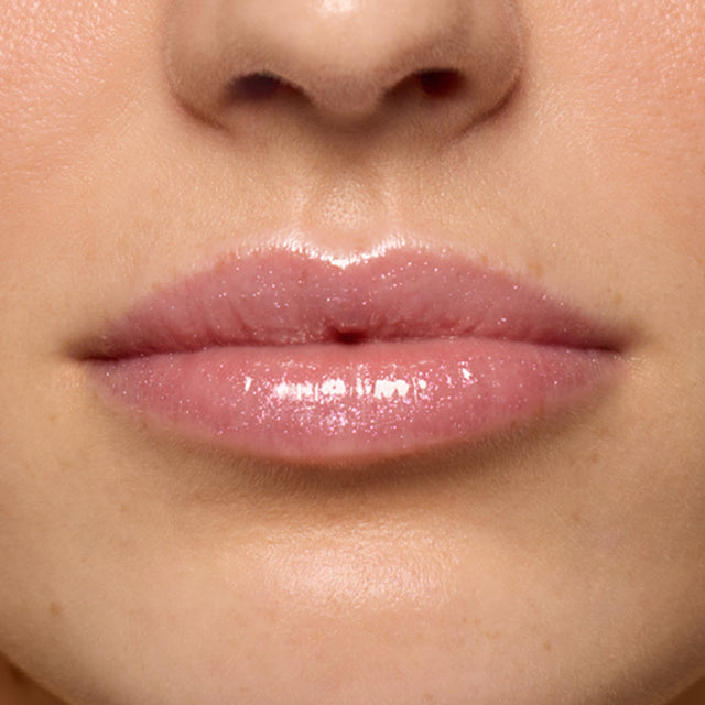 Light skin tone model wearing Lip Pulse in Aura Flare