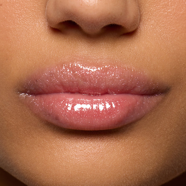 Medium skin tone model wearing Lip Pulse in Aura Flare