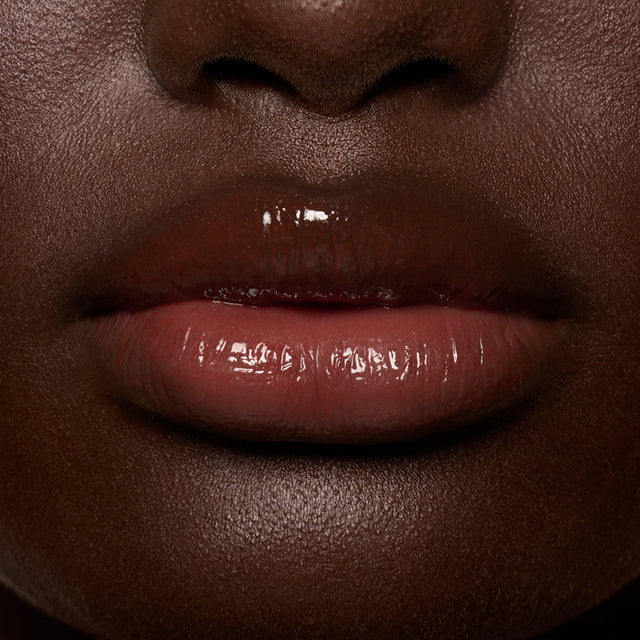Deep skin tone model wearing Lip Pulse in Soulfire