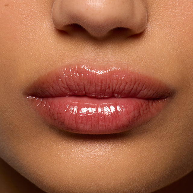 Medium skin tone model wearing Lip Pulse in Soulfire