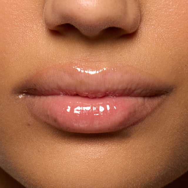 Medium skin tone model wearing Lip Pulse in Unspoken