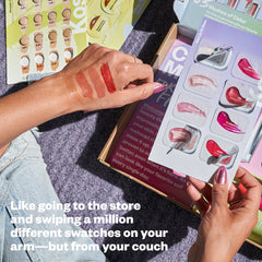 Image with a variety of different sample cards, testing shades on hand. Like going to the store and swiping a million different swatches on your arm, but from your couch.